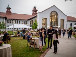 People mingling in front of College Hall at Montclair State University