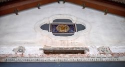 Stained glass window on former exterior wall with Montclair State College seal.