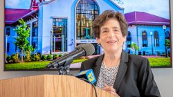 President Susan A Cole speaking from the podium