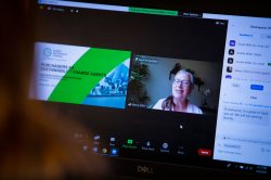over-the-shoulder view of keynote presentation being broadcast to a laptop