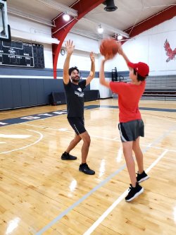 Koppell playing basketball with his son in Panzer Gymnasium