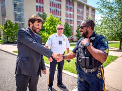 Koppel shaking hands with police officers