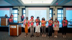 Seven EOF all-star scholars standing next to podium for recognition