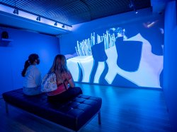 Two students viewing a projection at the Tech/Know/Future exhibit