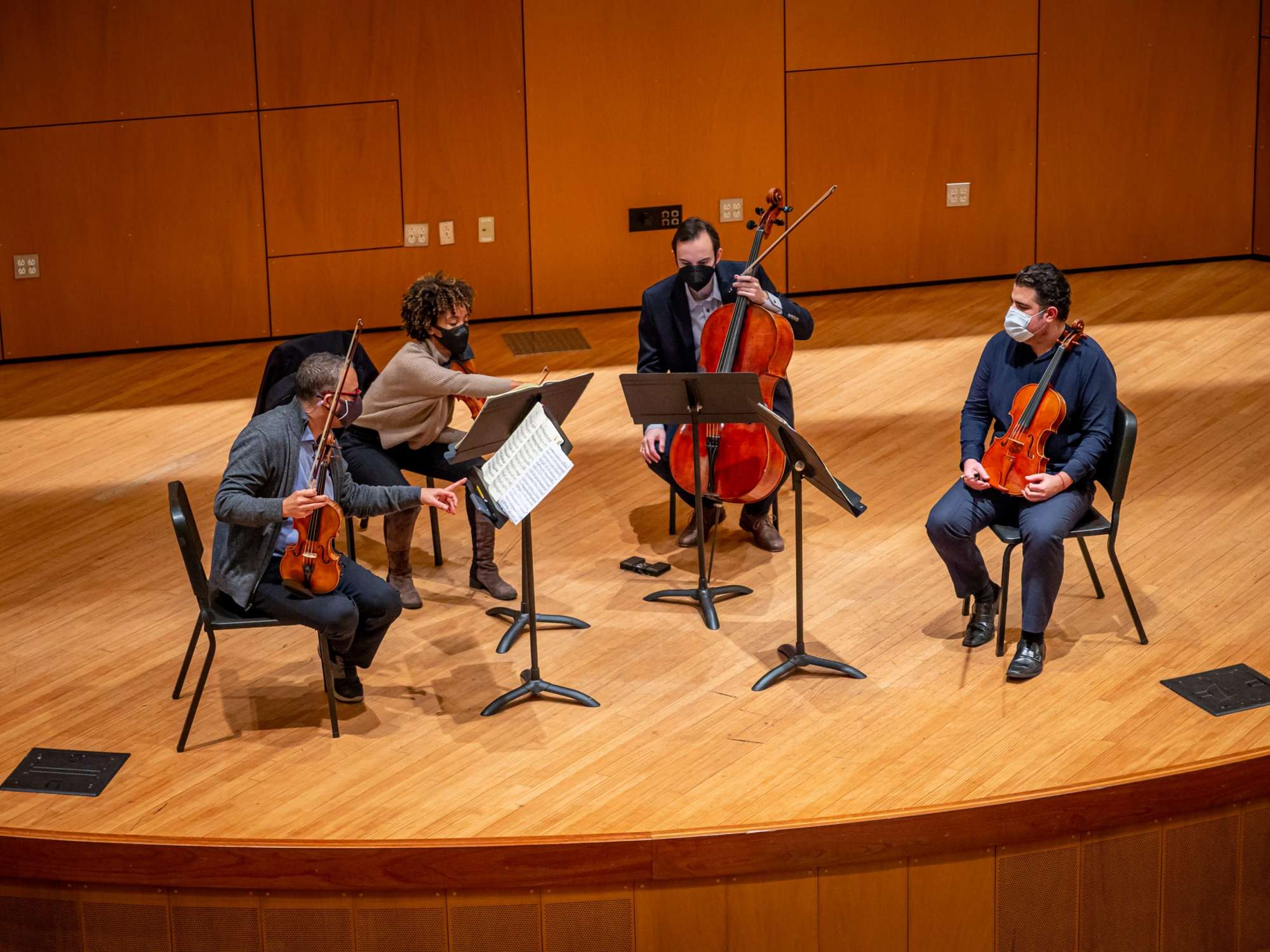 Members of the Harlem Quartet rehearsing on stage