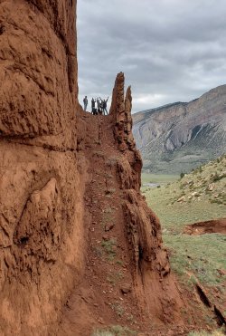 students at end of steep trail along cliff face