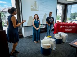 Robin Wilson speaking with students