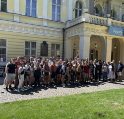 group of musicians pose outside the palace