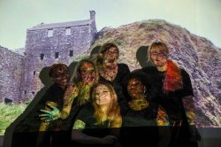 student performers pose in front of projection screen