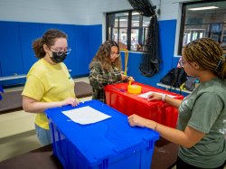 Student volunteers labeling containers