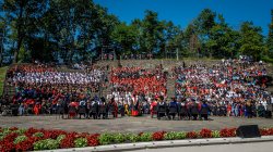 attendees seated in amphitheater on campus