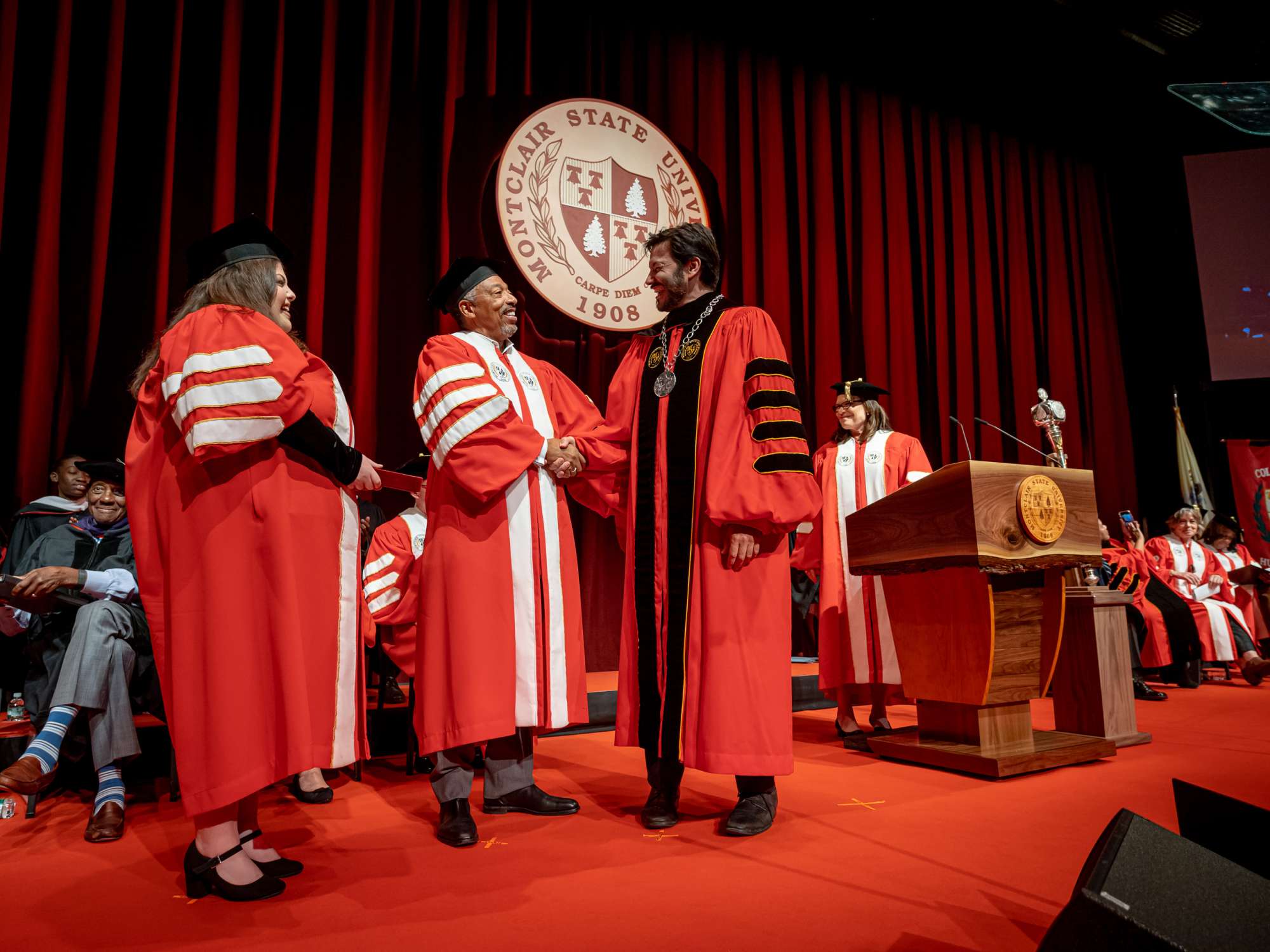 President Koppell shakes Trustee Preston Pinkett's hand