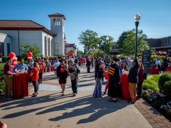 Attendees on campus at various tables