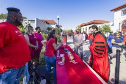 President Koppell talking with students over table