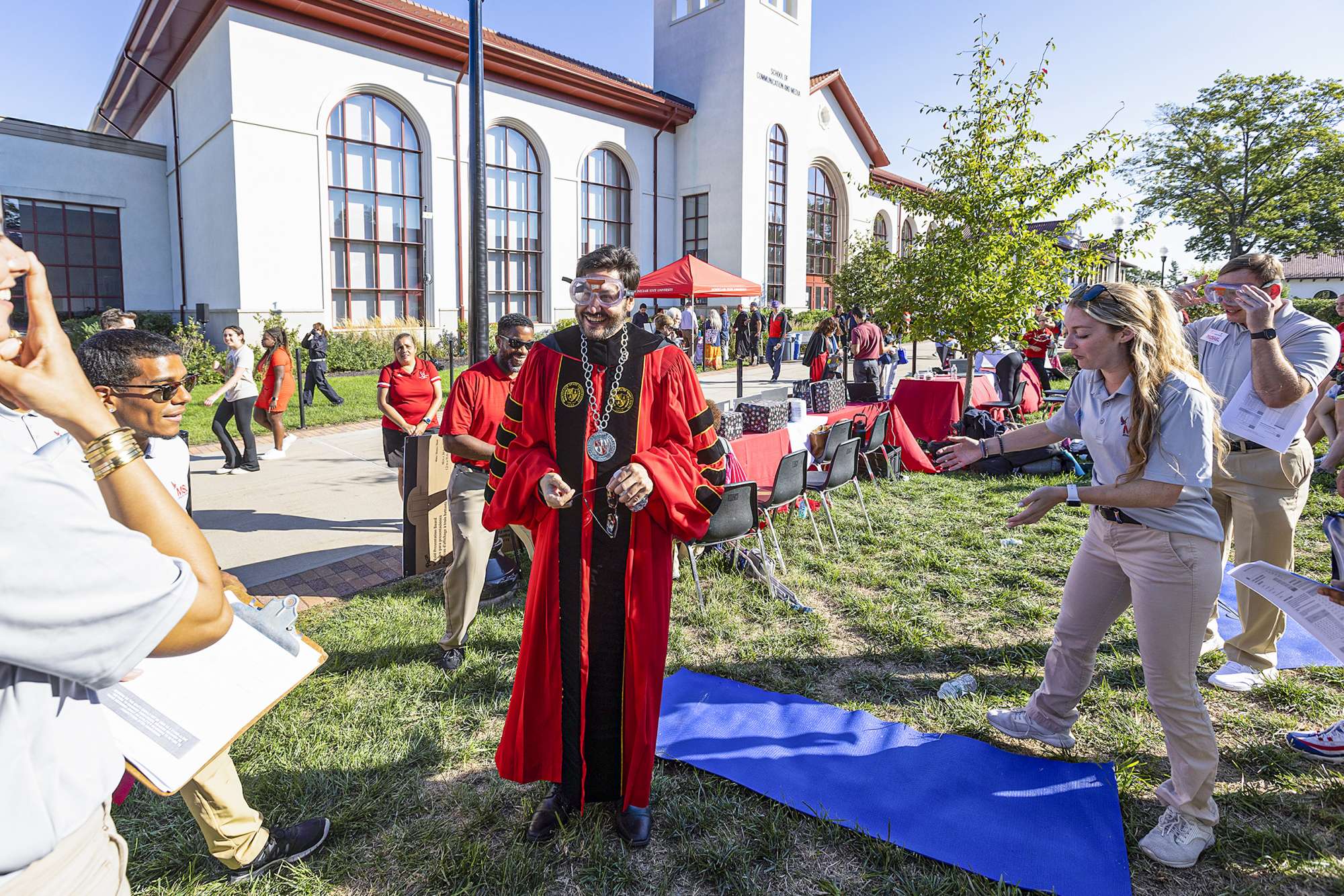 President Koppell wears goggles and poses for photograph