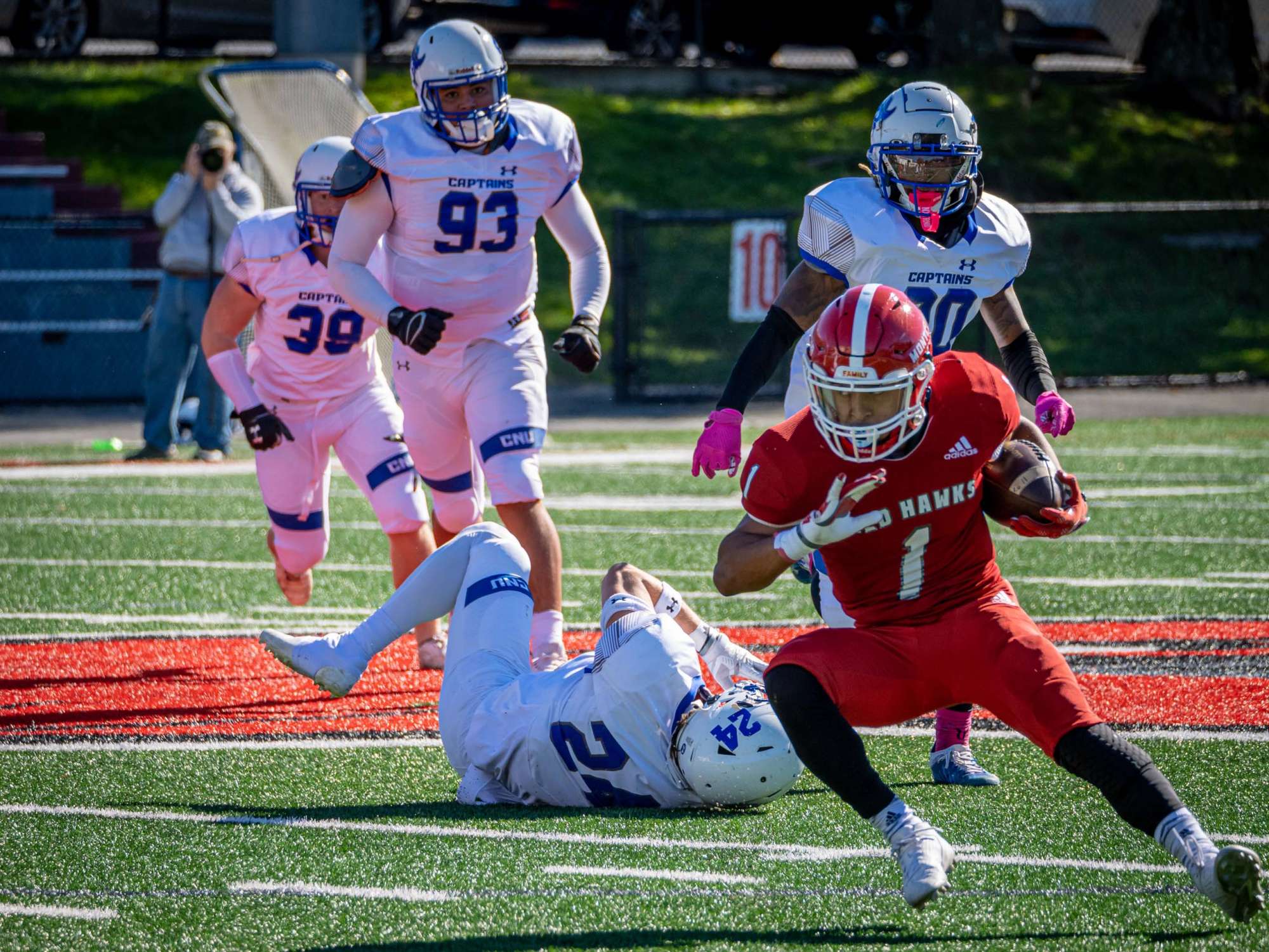 Football player holding ball and running