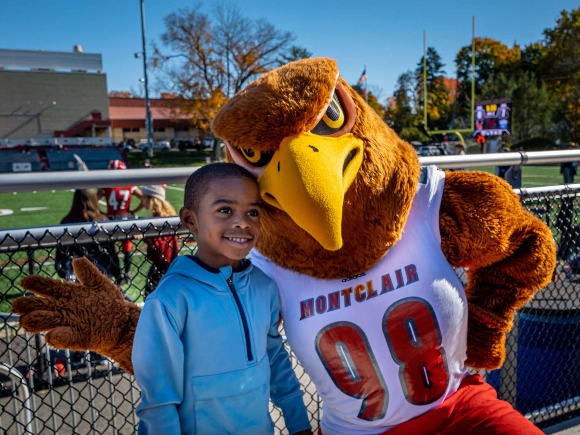 Rocky poses with young child