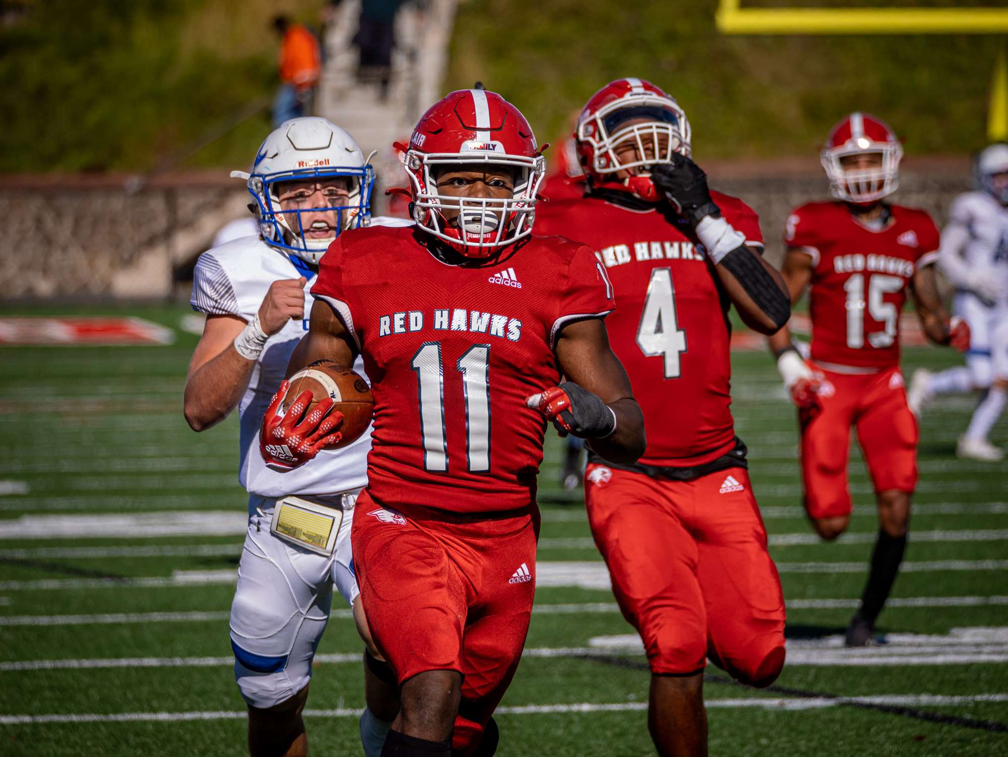 Red Hawk football player number 11 running for a touchdown