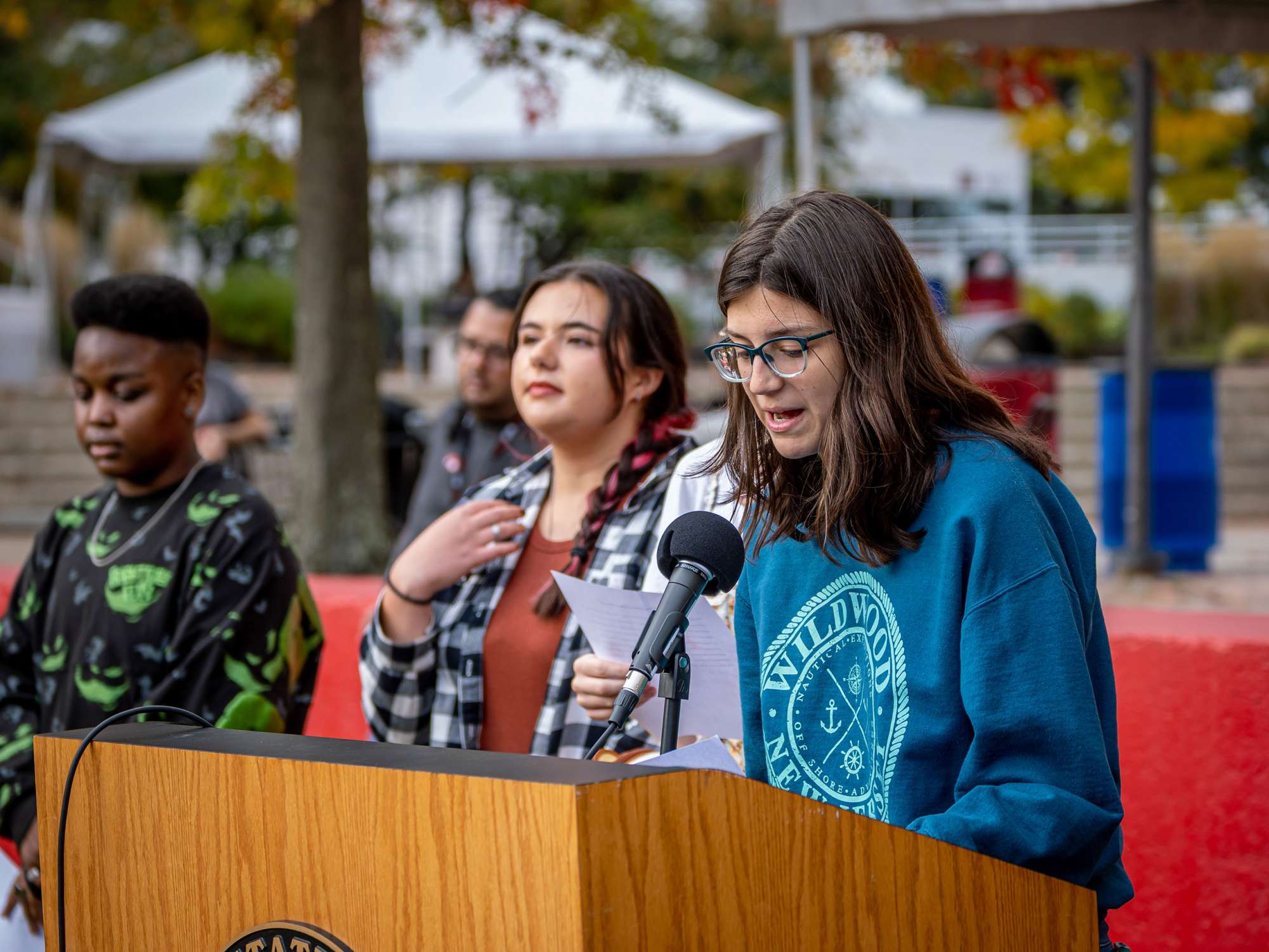 woman in blue shirt at podium