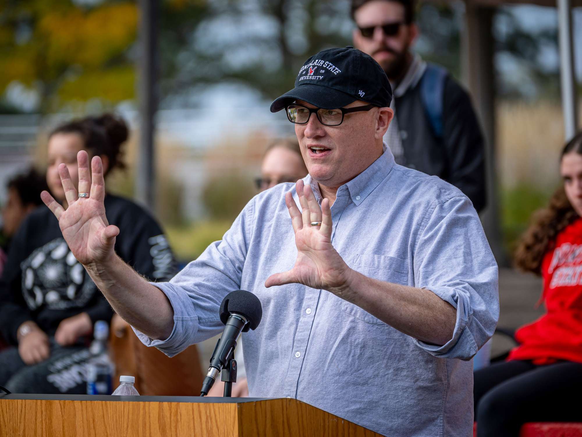 man in white shirt at podium