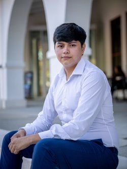 Student sitting on steps in front of kasser theater