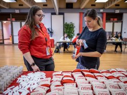 Two women check hygiene packages.