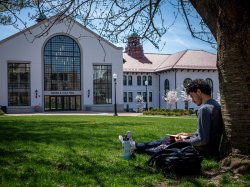 Student sitting outside Cole Hall
