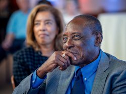 Irvin D. Reid watches as some speaks.