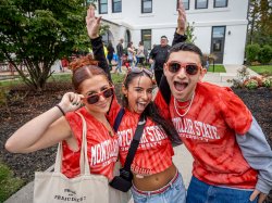 Three students laugh and pose for the camera.