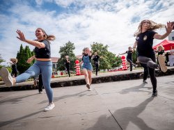 Students kick during a dance sequence.