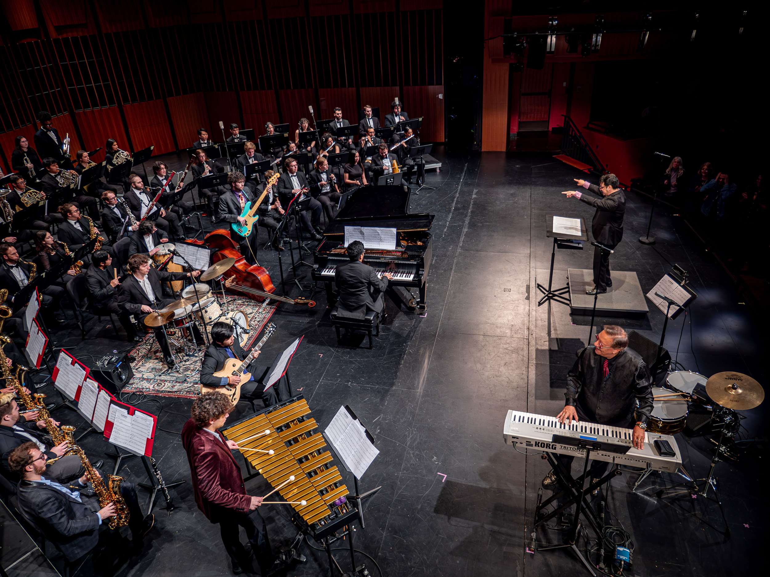 A conductor conducts a symphony.