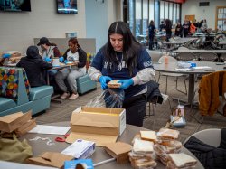A student packs a peanut butter and jelly sandwich.