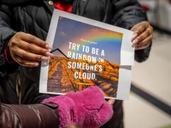 Two pieces of paper put together spell out "Try to be a Rainbow in Someone's Cloud," a quote from poet Maya Angelou.