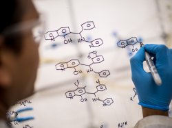 Scientist drawing up a molecular structure.