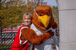 Vanessa Fingerlin hugs a white statue wearing a costumed bird head.