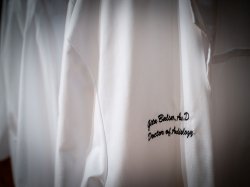 A closeup of the white coats presented to Audiology students.