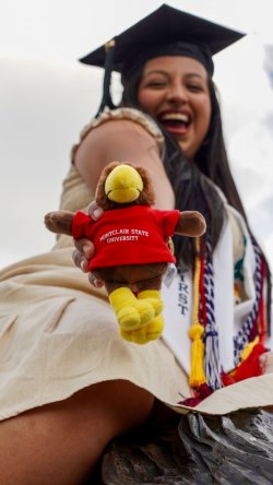 Aylin Alvarez-Santiago holds a mini stuffed bird mascot.