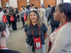A recent graduate is seen speaking with other students
