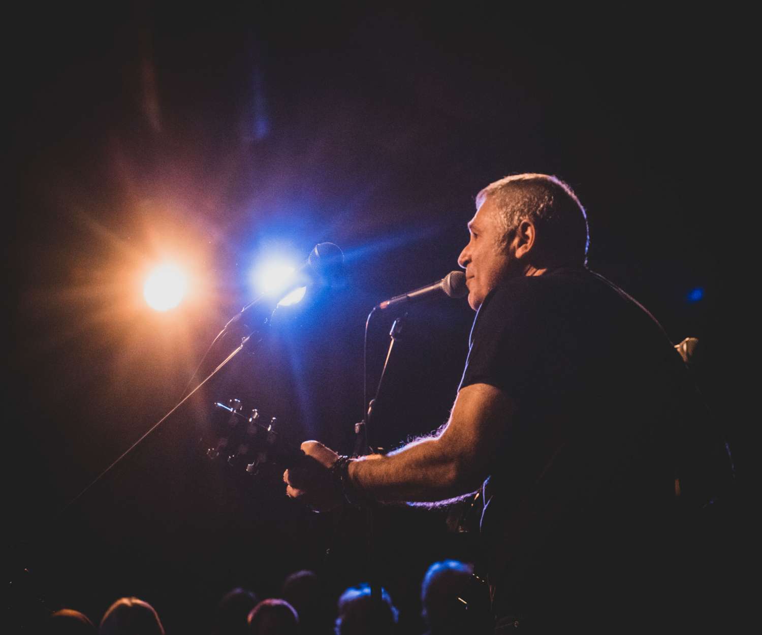 Jon Caspi sings and plays guitar onstage.