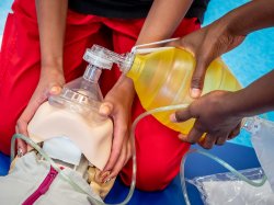 Closeup of nursing students hands during simulation assignment.