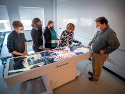 School of Nursing faculty and staff demonstrating a lesson on the Anatomage Table.