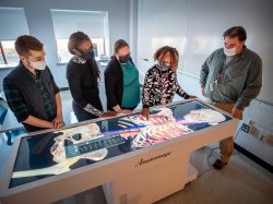 School of Nursing faculty demonstrating the Anatomage Table 8 in the Simulation Center.