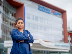 Nursing student standing in front of St. Barnabas Medical Center.