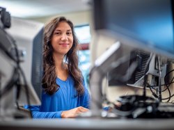 Female student sitting in front of a computer.