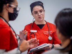 Student nurse holding a clipboard.