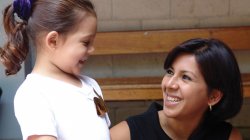 Child advocacy student smiling at young child
