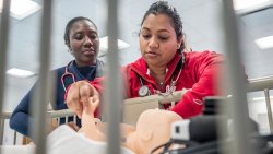 Photo of students in School of Nursing lab.