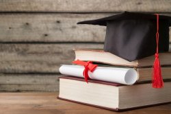 books, cap and diploma