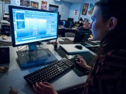 Animation and Visual Effects Professor at computer demonstrating 3D rigging techniques