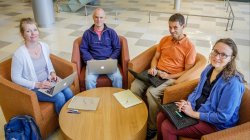 Image of Professors Goodey, Vanderklein, Galster, and Dalley around a small table